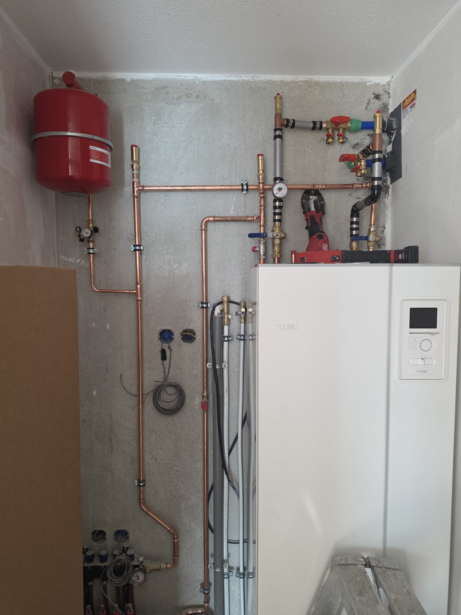 Modern boiler room with hydraulic installation and expansion tank.